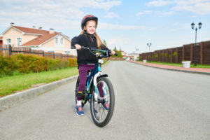 girl riding bike YSAQ8TK e1575411965440